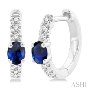 4X3 MM Oval Cut Sapphire and 1/10 ctw Petite Round Cut Diamond Fashion Huggies in 10K White Gold